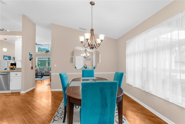 dining area featuring a chandelier and wood-type flooring