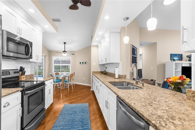 kitchen featuring ceiling fan, tasteful backsplash, sink, and stainless steel appliances