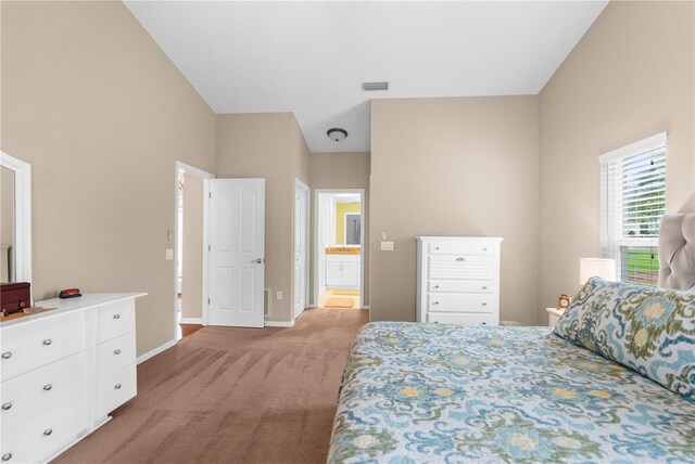 bedroom with light carpet and ensuite bathroom