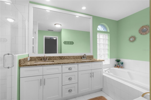 bathroom featuring plus walk in shower, tile patterned floors, and vanity