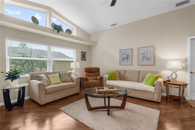 living room with high vaulted ceiling and dark wood-type flooring