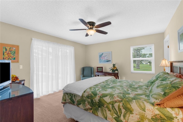 bedroom featuring carpet, a textured ceiling, and ceiling fan