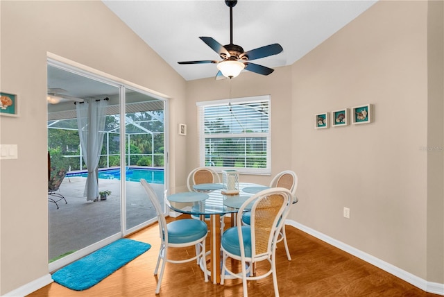 dining room featuring ceiling fan, vaulted ceiling, and hardwood / wood-style flooring