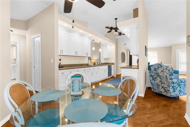 dining area with sink, ceiling fan, and hardwood / wood-style flooring