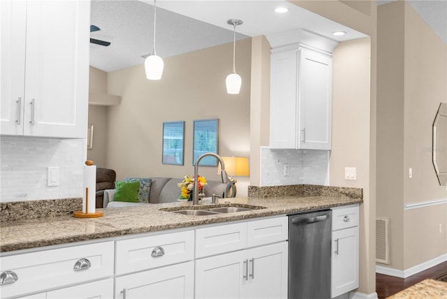 kitchen featuring dishwasher, tasteful backsplash, sink, light stone countertops, and hardwood / wood-style flooring