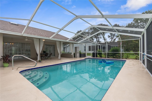 view of pool featuring ceiling fan, glass enclosure, and a patio