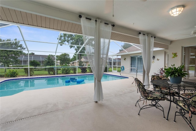 view of pool featuring ceiling fan, a lanai, and a patio area