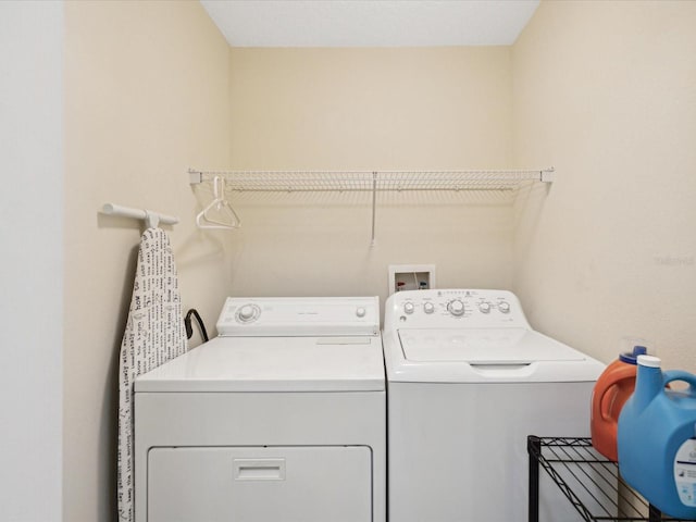 clothes washing area featuring independent washer and dryer