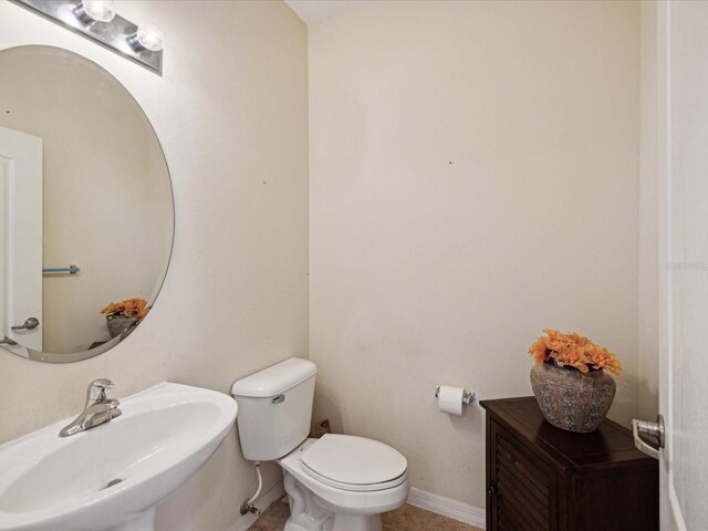 bathroom with tile patterned floors, toilet, and sink