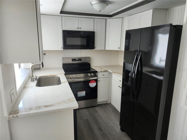 kitchen featuring sink, white cabinets, black appliances, and dark hardwood / wood-style floors