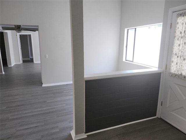 empty room with dark hardwood / wood-style flooring and ceiling fan