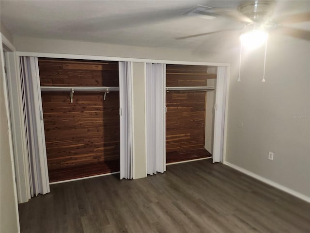 unfurnished bedroom with dark wood-type flooring and a ceiling fan