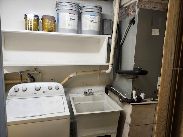 washroom with washer / clothes dryer, a sink, and laundry area