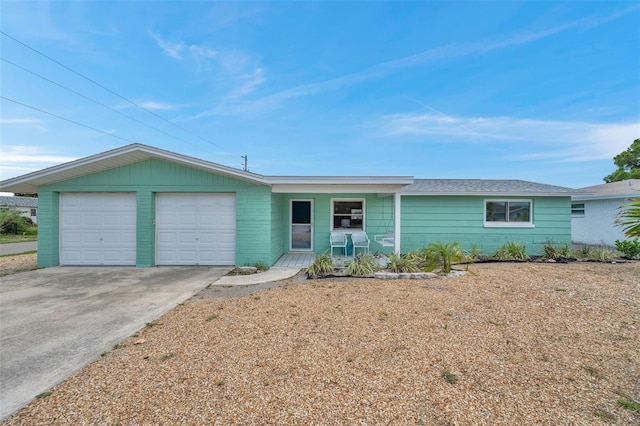 ranch-style home with a garage and covered porch