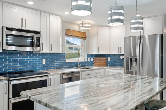 kitchen featuring sink, stainless steel appliances, white cabinets, and tasteful backsplash