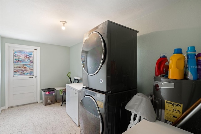 laundry room with stacked washing maching and dryer and water heater