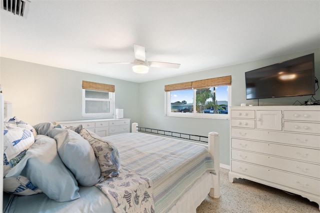 bedroom featuring ceiling fan and a baseboard heating unit