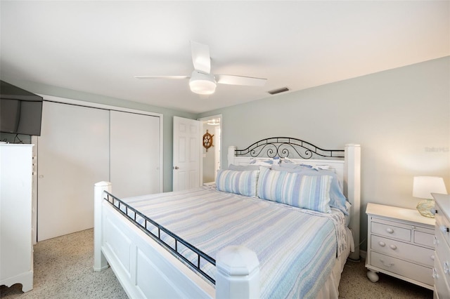 bedroom with ceiling fan and a closet