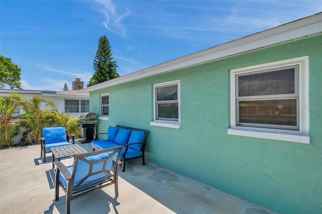 view of patio with an outdoor living space and area for grilling