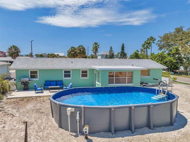 view of pool featuring an outdoor living space and a patio area