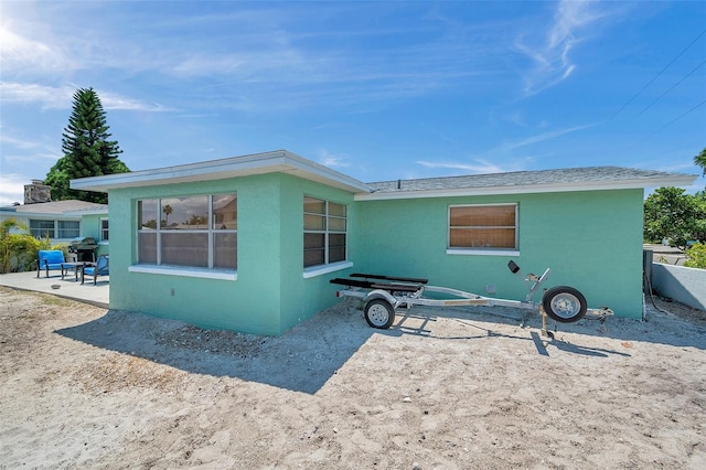 back of property with a patio