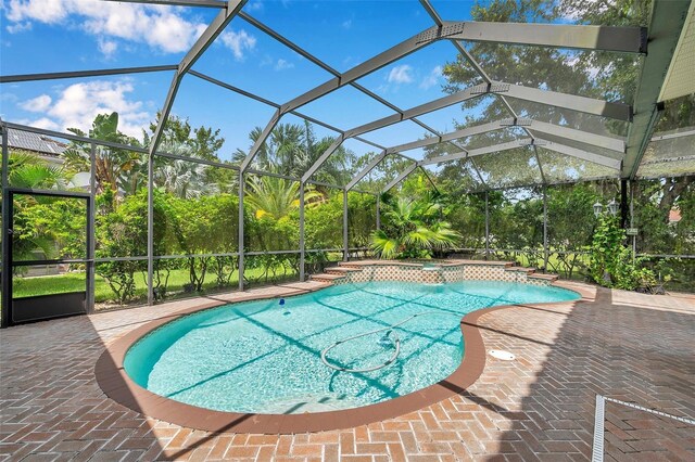 view of pool featuring a patio and glass enclosure