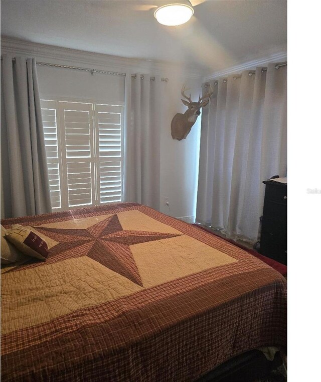 bedroom featuring crown molding