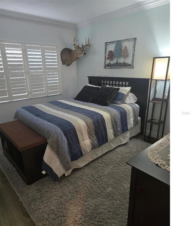 carpeted bedroom featuring ornamental molding