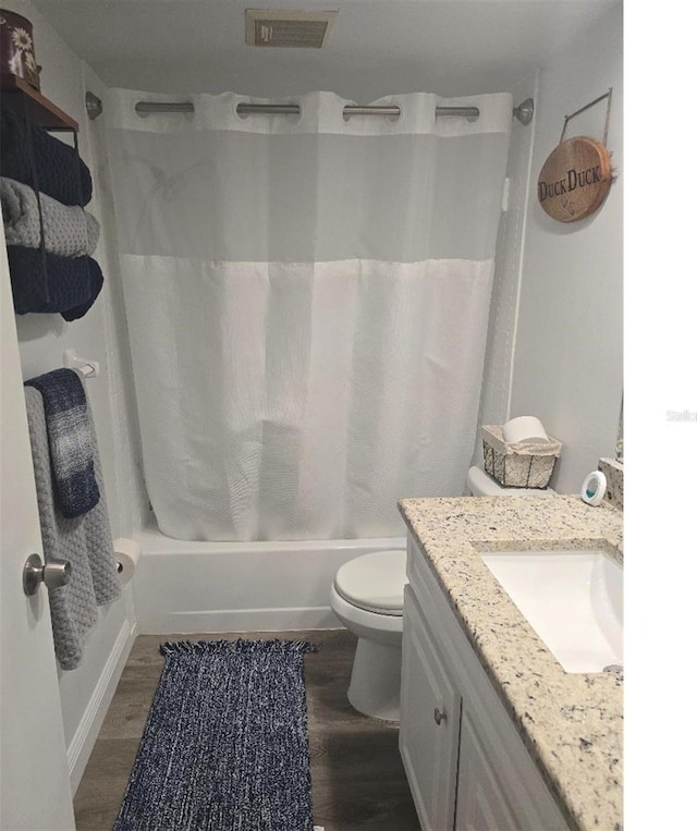 full bathroom with vanity, toilet, hardwood / wood-style flooring, and shower / bathtub combination with curtain