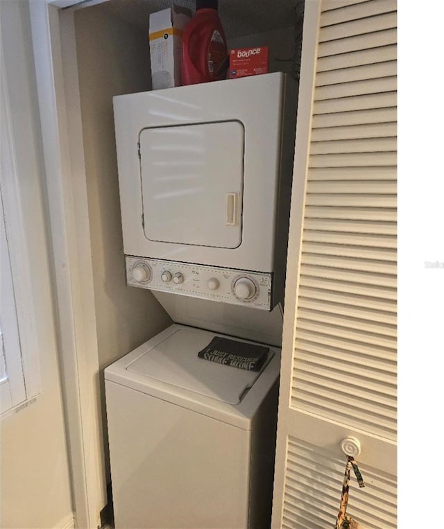 laundry area with stacked washing maching and dryer