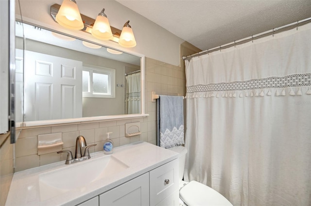 bathroom with tile walls, tasteful backsplash, toilet, vanity, and a textured ceiling