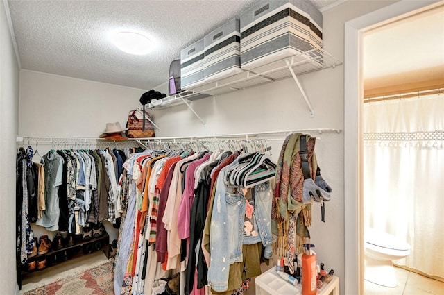 spacious closet featuring tile patterned flooring