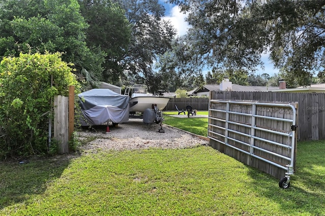 view of yard featuring fence and driveway