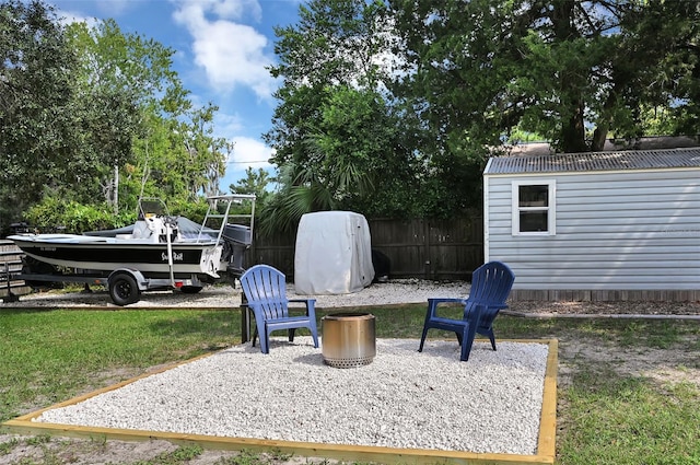 view of yard with fence, a patio, and an outdoor structure