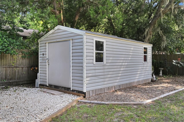 view of shed featuring fence