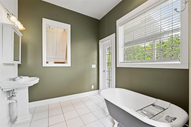 bathroom featuring a tub to relax in and tile patterned floors