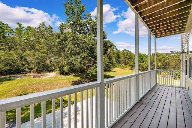 wooden terrace with a yard