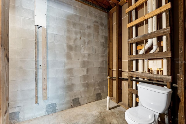 bathroom with concrete flooring and toilet