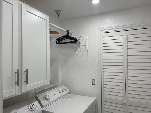 laundry area featuring independent washer and dryer and cabinets