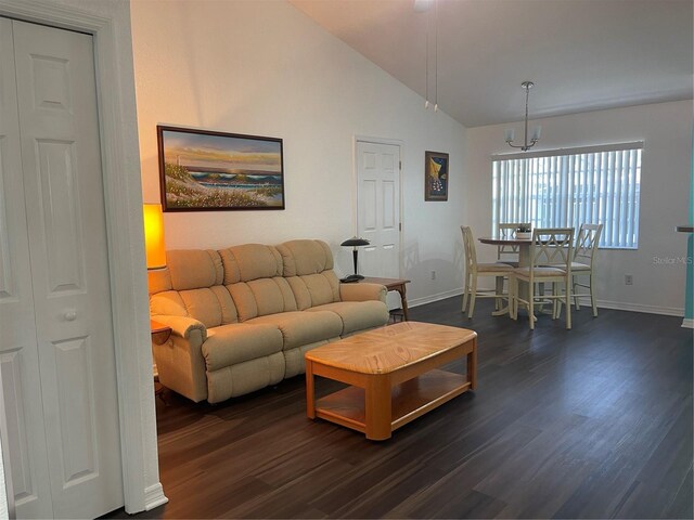 living room featuring dark hardwood / wood-style flooring and vaulted ceiling