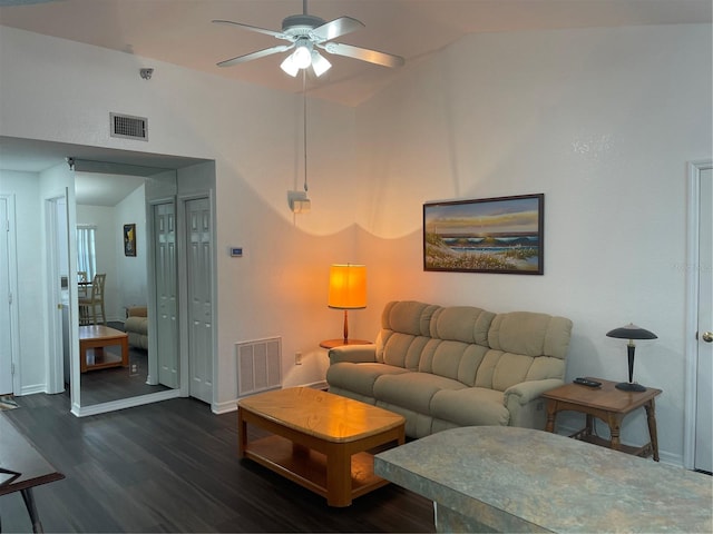 living room featuring vaulted ceiling, dark wood-type flooring, and ceiling fan