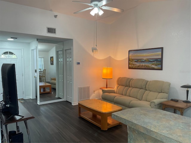 living room featuring ceiling fan and dark hardwood / wood-style floors