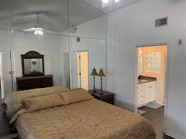 bedroom with sink, ceiling fan, high vaulted ceiling, ensuite bathroom, and dark hardwood / wood-style flooring