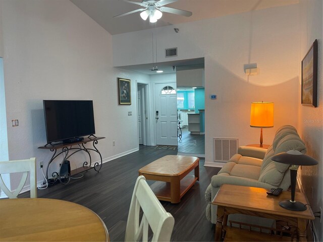 living room with dark hardwood / wood-style flooring, lofted ceiling, and ceiling fan