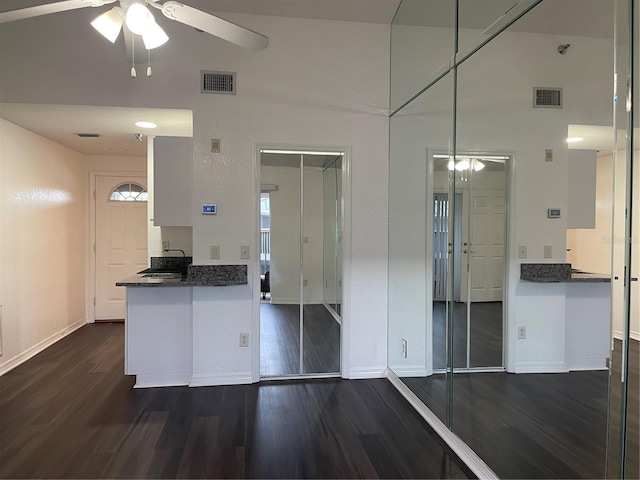 kitchen featuring white cabinetry, pendant lighting, dark hardwood / wood-style flooring, and ceiling fan