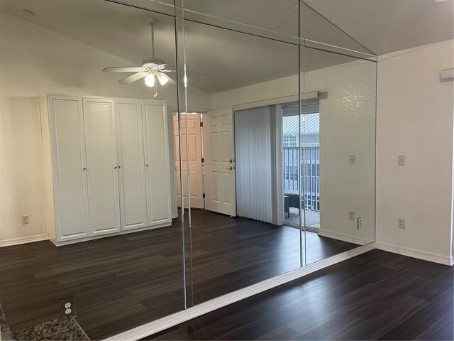 interior space featuring lofted ceiling, dark hardwood / wood-style floors, and ceiling fan