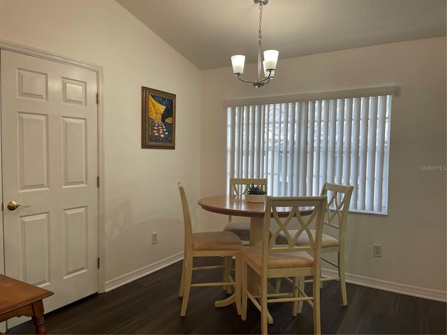 dining space featuring dark hardwood / wood-style floors, a chandelier, and vaulted ceiling