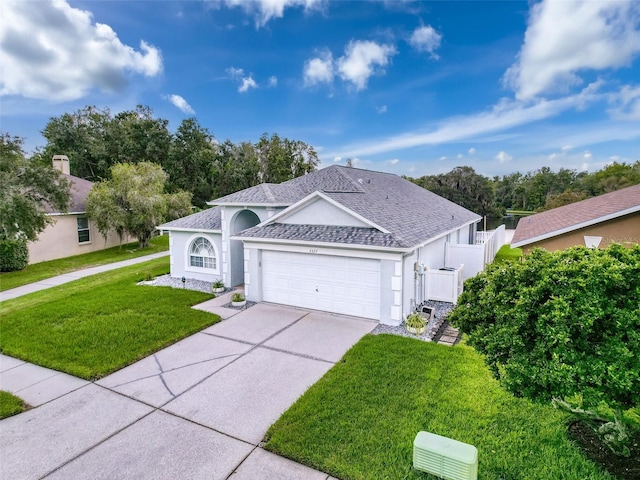 view of front facade with roof with shingles, stucco siding, a front lawn, concrete driveway, and a garage