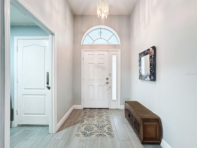 entryway with baseboards and wood tiled floor