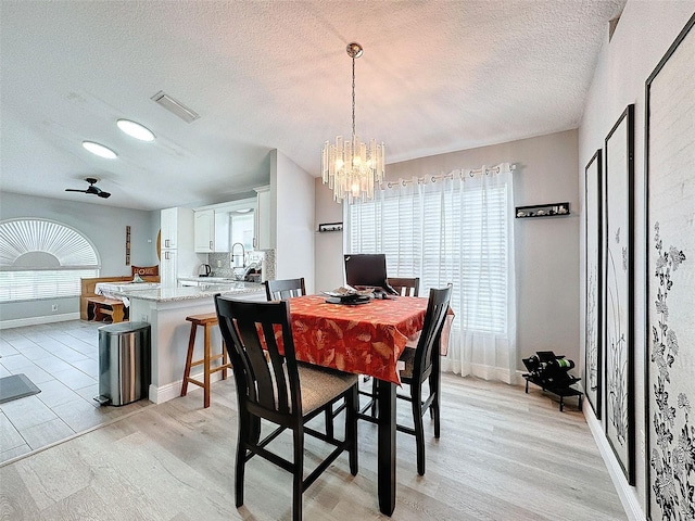 dining space featuring visible vents, a healthy amount of sunlight, and light wood-type flooring